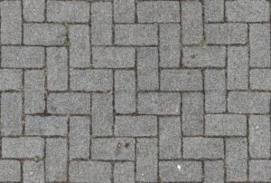 Close-up of interlocking gray brick pavement. Ideal for urban, texture, and construction themes.